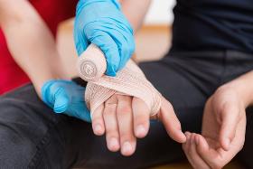First aid courses employer training. Health and safety, wrapping  wound.